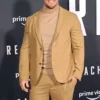 Side profile showing full length sleeves and open hem cuffs of Jack Reacher brown suit