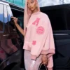 Side view of Angel Reese Custom Coach Pink Wool Varsity Jacket with PU leather sleeves