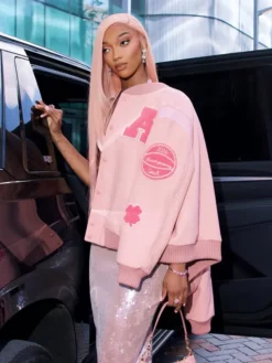 Side view of Angel Reese Custom Coach Pink Wool Varsity Jacket with PU leather sleeves