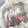 Close-up of Kanye West LA MASKARADE Tiger White Zip Hooded Jacket