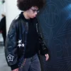Close-up of WNBA Olivia Miles Coach Black Leather Varsity Jacket