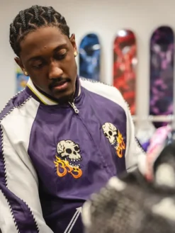 Close view of Jalen Williams A Bathing Ape Purple And White Souvenir Skull Satin Bomber Jacket