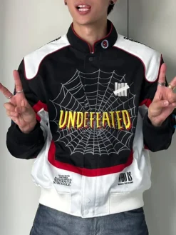 Undefeated x Spider-Man FW26 Varsity Jacket featuring erect collar, rib-knit cuffs, and snap-tab closure