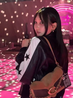 Close-up of Lilas Ikuta Coach Spring 2027 Black And White Star Bomber Leather Jacket