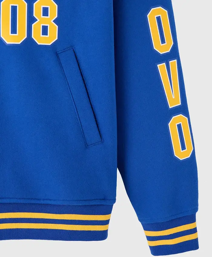 Close-up of October's Very Own x Degrassi Royal Blue Fleece Letterman Varsity Jacket