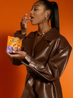 Close-up of WNBA Angel Reese x Reese's Pieces Chocolate Brown Leather Jacket