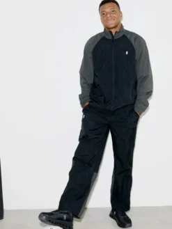 Close view of French Soccer Player Kylian Mbappe Black And Grey On Polyester Tracksuit