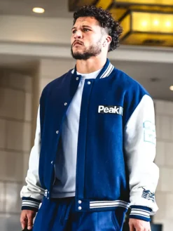 Close view of NFL Los Angeles Rams Blake Corum Arrival Peak Navy And White Varsity Letterman Jacket