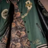Close view of Avengers Doomsday NYCC 2026 Heroes and Villains Doctor Doom Supreme Ruler Without Rival Green Varsity Jacket